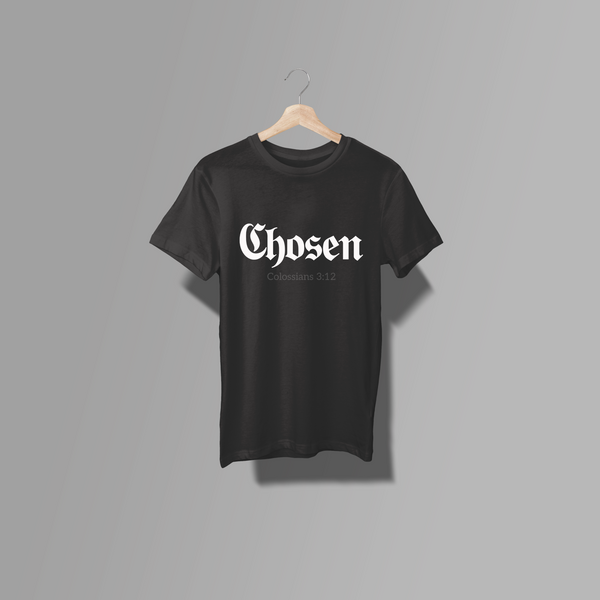 A black short-sleeve crewneck t-shirt hanging on a light wood hanger against a solid gray background. The shirt features the word 'Chosen' in a white Gothic font across the chest, with 'Colossians 3:12' printed in smaller white text underneath.