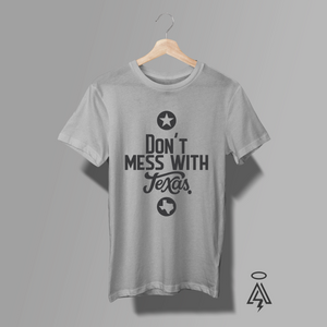 A bold statement piece with roots as strong as the Lone Star State. This heather gray tee features a striking monochrome design that reads “Don’t Mess With Texas,” blending classic Texas pride with a modern typographic edge.