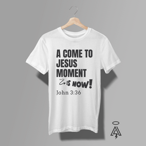 A white short-sleeve t-shirt. The shirt features a black typographic graphic on the front that reads 'A COME TO JESUS MOMENT & IS NOW! John 3:36'.
