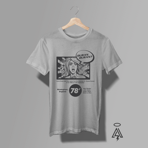 This T-shirt features a bold, black-and-white graphic design that blends retro comic-book art-Duran Duran. She has dramatic, open-mouthed expression, with a speech bubble above her that reads “DURAN DURAN?” — a playful nod to the band’s name and its origin from the Barbarella film character Dr. Durand Durand.