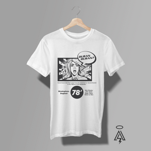 This T-shirt features a bold, black-and-white graphic design that blends retro comic-book art-Duran Duran. She has dramatic, open-mouthed expression, with a speech bubble above her that reads “DURAN DURAN?” — a playful nod to the band’s name and its origin from the Barbarella film character Dr. Durand Durand.