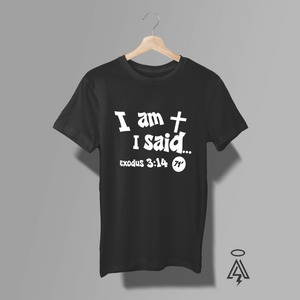 A black short-sleeve t-shirt, featuring the a cross, white text 'I am + I said and Exodus 3:14.