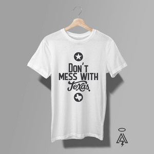 White tee features a striking monochrome design that reads “Don’t Mess With Texas,” blending classic Texas pride with a modern typographic edge.