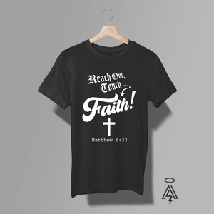 The “Reach Out, Touch Faith!” black tee takes a familiar lyric-inspired phrase and flips it into a powerful, scripture-rooted declaration. Anchored by a cross and the verse Matthew 6:33, this design shifts the message from cultural reference to Kingdom focus. It’s not about reaching for a feeling — it’s about reaching for Him. Seeking first the Kingdom. Touching something eternal.