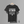A black short-sleeve graphic T-shirt. The shirt features white text reading 'THE BOYS ARE BACK IN TOWN' followed by a list of the Disciples.